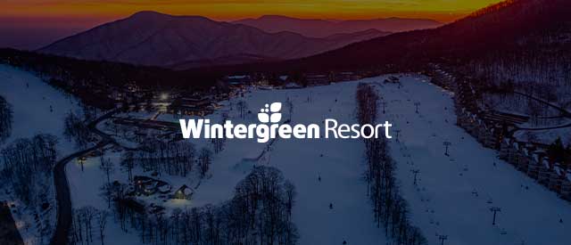 Wintergreen Resort logo over an image of the restaurant dining tables with a fall view of aspen trees faded out.
