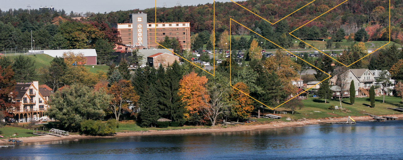 View of Wisp Resort facilities from across a lake on an autumn day.